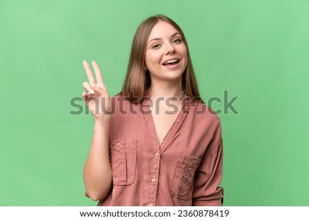 Young beautiful blonde woman over isolated background smiling and showing victory sign