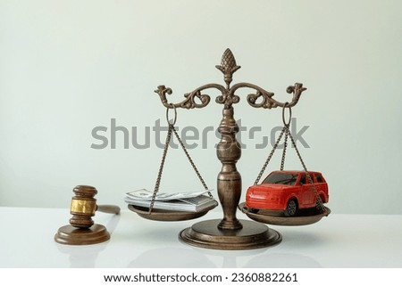 court room Gavels and small toy car models On the scales in the court Attorney services Trial in the Civil Court in a case study of a car accident and insurance