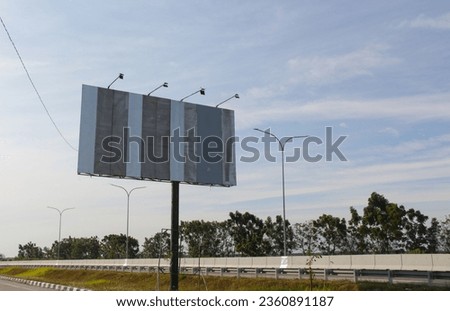 blank empty advertising billboard in the highway with cloudy sky