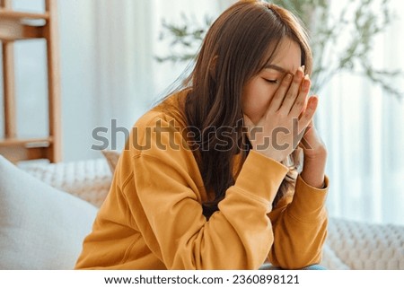 Sad tired young asian woman touching forehead having headache migraine or depression, upset frustrated girl troubled with problem feel stressed, Grief sorrow concept Royalty-Free Stock Photo #2360898121