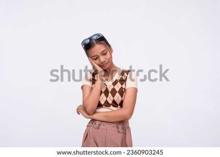 A young asian woman tries to remain calm and endures a throbbing toothache. Isolated on a white background. Royalty-Free Stock Photo #2360903245