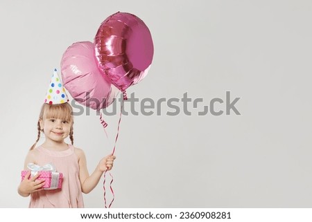 Portrait of young girl kid with balloon on white background. Pretty child with pink balloon. Happy Birthday party concept