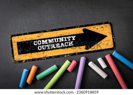 COMMUNITY OUTREACH. Yellow directional arrow with text on a dark chalkboard background.