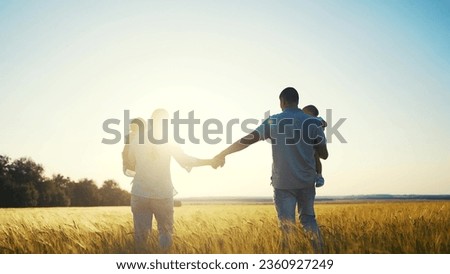 happy family in park wheat field. friendly family walks in wheat field with two children baby toddlers in summer. happy family kid dream concept. big family silhouette sunset in wheat field