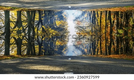 Futuristic picture of rural autumn road. The road looks like reflected in the sky.