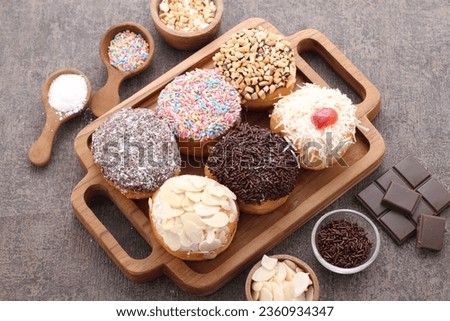 donuts of various shapes with colorful toppings with a variety of sweet and savory flavors
