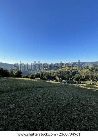 mountains, green field with beautiful clear sky. Nature