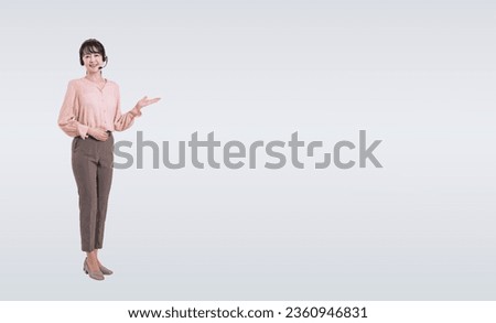Asian middle-aged woman giving a lecture while wearing a headset. Royalty-Free Stock Photo #2360946831