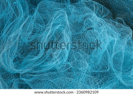 Blue Fishing net, Fisherman hunting tools, net rope texture, pattern net, Abstract Background. Royalty-Free Stock Photo #2360982109