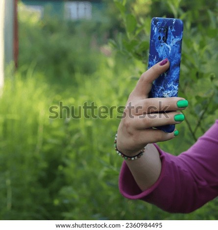 a smartphone in a woman's hand
