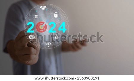 Businessman holding light bulb with target to 2024 for preparation for happy new year concept. new business in new year, start up, action plan and strategy in new business.