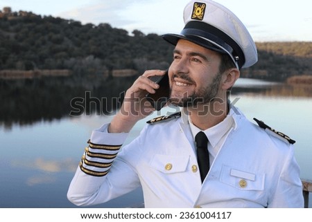 Ship captain making an international call  Royalty-Free Stock Photo #2361004117