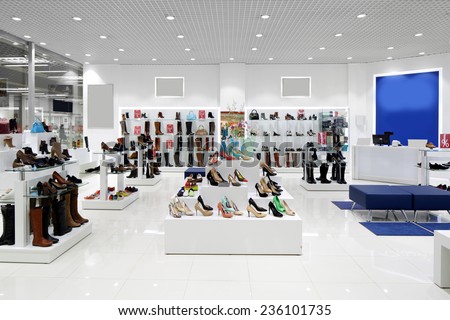 bright and fashionable interior of shoe store in modern mall Royalty-Free Stock Photo #236101735