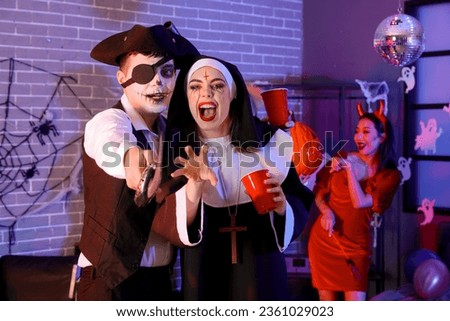 Young couple in costumes at Halloween party