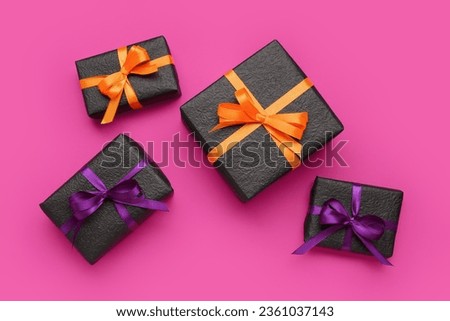 Set of gift boxes for Halloween celebration on pink background