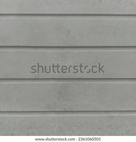 photo of a house building's cast concrete foundation with straight line motifs