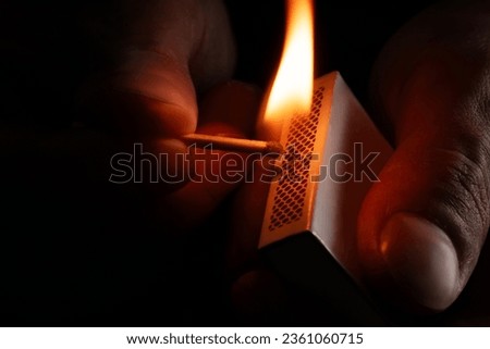 Firing point safety match. Close-up view to strike matches for matchbox. Detail of ignition matches for matchbox. Macro lighting of a match striking out a matchbox. Closeup safety match flame. Royalty-Free Stock Photo #2361060715