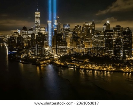 An aerial view of the Freedom Tower in New York City at night, while the tribute in light twin beams are illuminated.