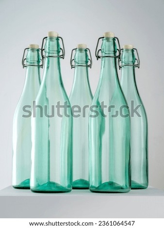 Transparent glass bottles on white background