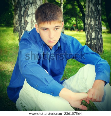 Toned photo of Sad Teenager in the Summer Park
