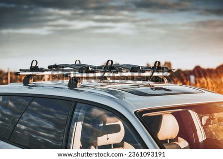 Versatile Roof Rack for Station Wagons: Safely Transporting Sports Equipment and Big Items. A roof rack or bar on a station wagon or estate car. Transportation of sports equipment in the family car. Royalty-Free Stock Photo #2361093191