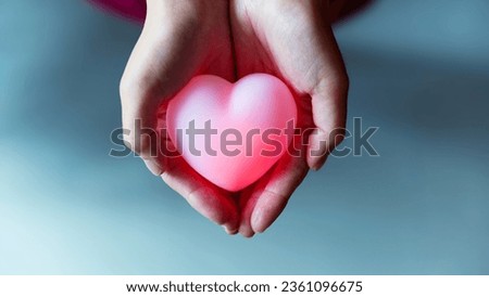 Human hand holding a red heart
