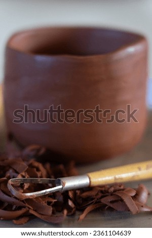 Ceramic vase with clay tools seen up close