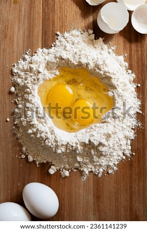 white eggs and wheat flour preparing to make pasta