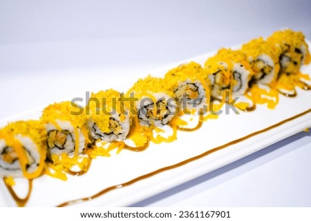 California Sushi roll with cheese on top and white background