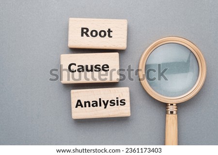 Root Cause Analysis (RCA) text on wood blocks with magnifying glass Royalty-Free Stock Photo #2361173403