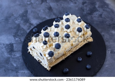 Top view of the delicious meringue roll. Protein dessert with blueberries