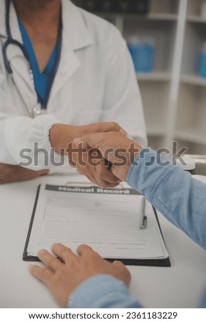 Smiling young female doctor shake hand close health insurance deal with elderly patient at consultation in hospital. Happy woman GP handshake greeting get acquainted with mature man in clinic. Royalty-Free Stock Photo #2361183229