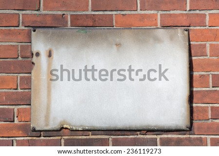 blank retro rusty metal sign on brick wall