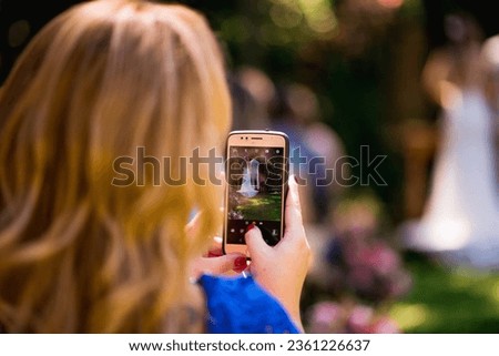 Woman taking wedding selfie outdoors