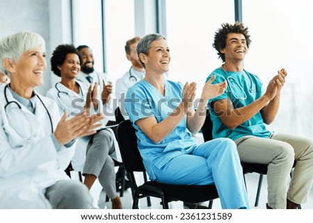 Portrait of a young doctors and nurses in audiance during a seminar in a board room or during an educational class at convention center  Royalty-Free Stock Photo #2361231589