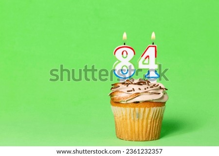 Birthday Card With Cupcake And Number 84 Candle; Photo On Green Background.