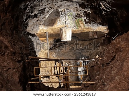 Underground of the historic silver mine in Tarnowskie Gory, a UNESCO heritage site. The "God bless" shaft with a visible bucket for transport. Royalty-Free Stock Photo #2361243819