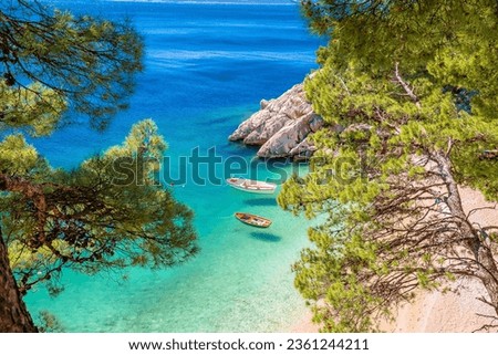 Idyllic beach Punta Rata in Brela view through Mediterranean trees, Makarska riviera of Dalmatia, Croatia Royalty-Free Stock Photo #2361244211