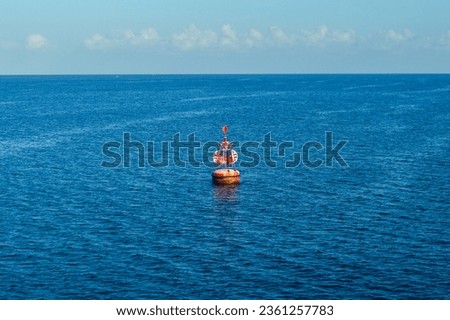 selective focus, red beacon buoy, marine navigation tool in the waters.