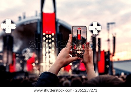 Crowd Enjoying a Summer Outdoor Music Festival and Taking Pictures via Smartphones