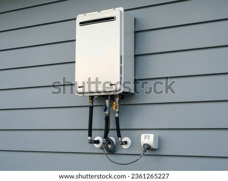 Modern external continuous flow gas water heater mounted on house wall Royalty-Free Stock Photo #2361265227