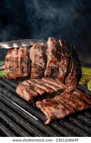 mexican style carne asada, charcoal grill for grilling arrachera and sirloin style meat, carne asada from northern mexico, carne asada tacos from sonora, traditional mexican food.
