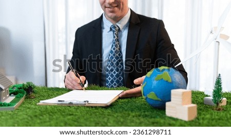 Businessman or CEO in office signing environmental regulation agreement to save Earth with sustainable energy utilization and CO2 reduction for greener future. Quaint