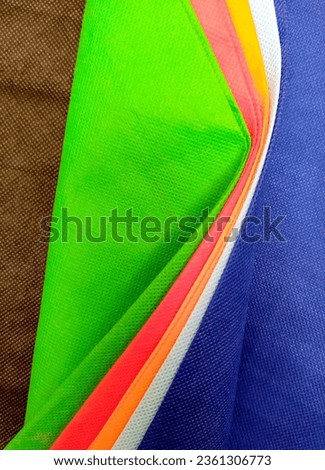 Bandung, Sept 14, 2023 : Colorful bunch of nylon fabric folds background at home.