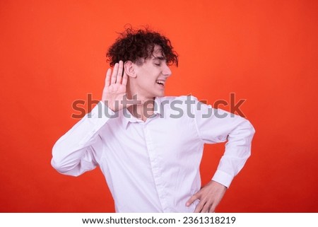 Study and work. Attractive curly student posing on an orange background.