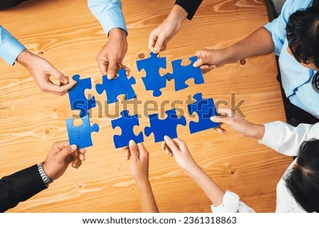 Top view multiethnic business people holding jigsaw pieces and merge them together as effective solution solving teamwork, shared vision and common goal combining diverse talent. Habiliment Royalty-Free Stock Photo #2361318863