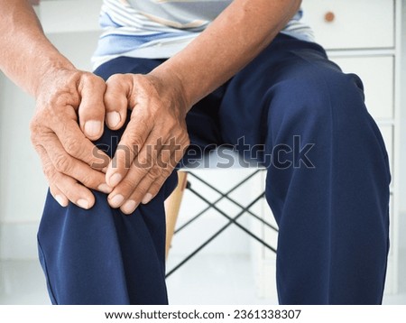 Asian man in suffering from knee pain at home, Health concept. Royalty-Free Stock Photo #2361338307