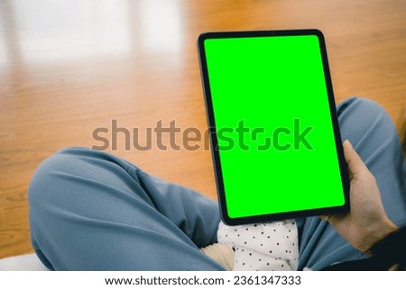 Blank screen tablet green background for text message or advertising copy space. Technology and lifestyle concept. 