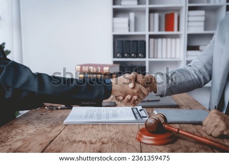Businessman handshake to seal a deal with his partner lawyer or attorney discussing a contract agreement.