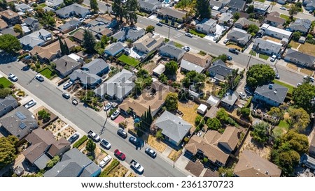 Top down view of houses in a neighborhood in Castro Valley, California with cars houses, streets and yards